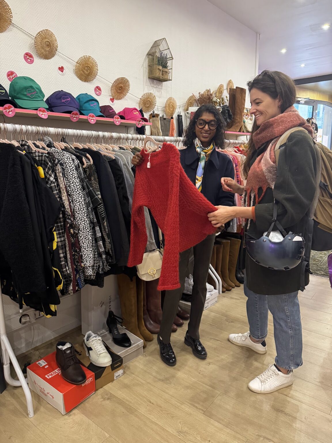 woman shopping in a luxury boutique with a personal stylist selecting premium garments